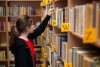 Teen browsing library books