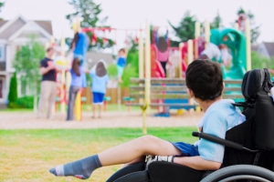 Child in wheelchair watching playground