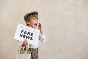 boy holding fake newspaper