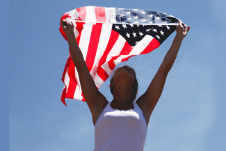 woman with flag raised above her head