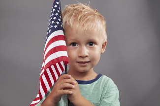 young boy holding a flag